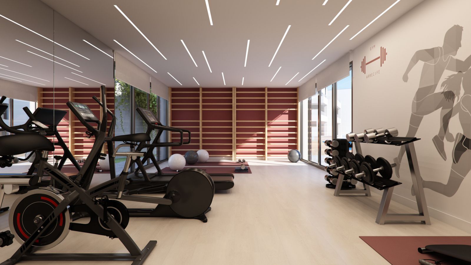 Indoor gym in Arrecife met fitnessapparatuur zoals een hometrainer, loopband en gewichten.